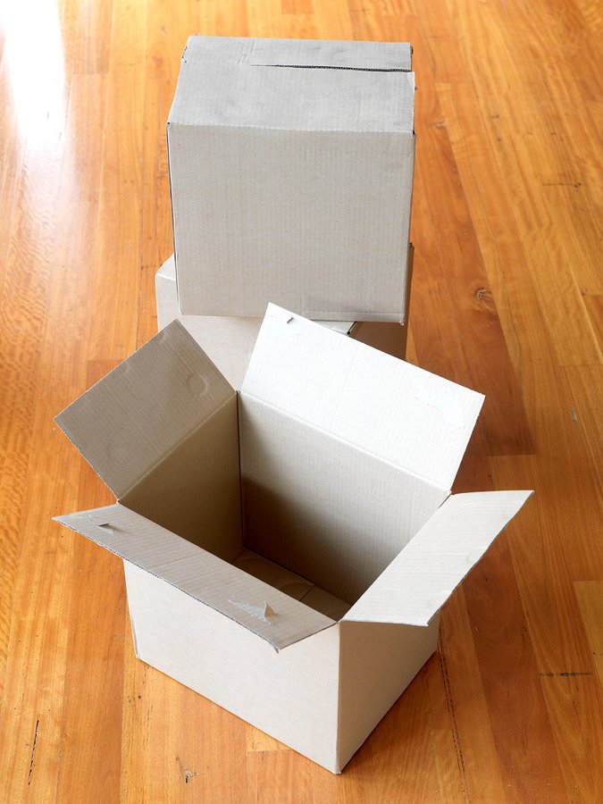 Cardboard boxes isolated on a wooden floor.